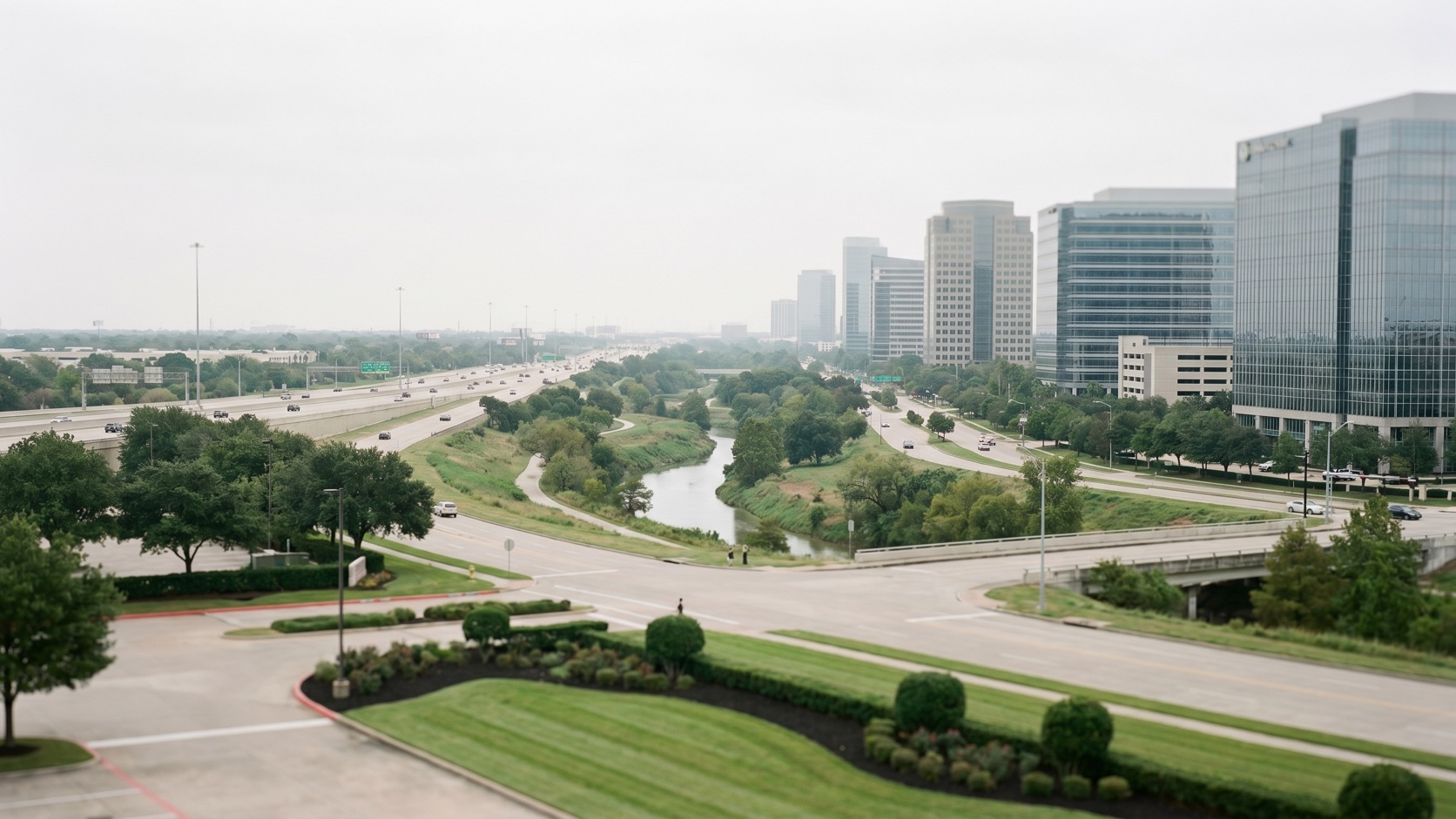 Elevated dusk view of Houston's Energy Corridor office towers and green bayou corridors