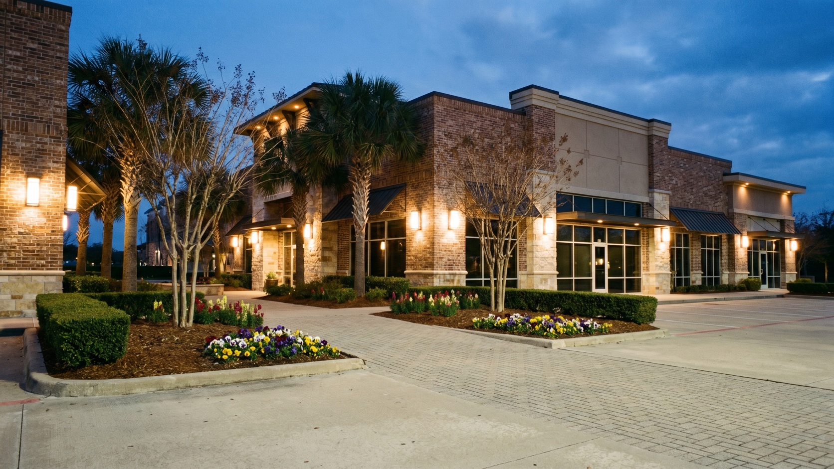 Clean, polished commercial office exterior with manicured landscaping at blue hour in Houston